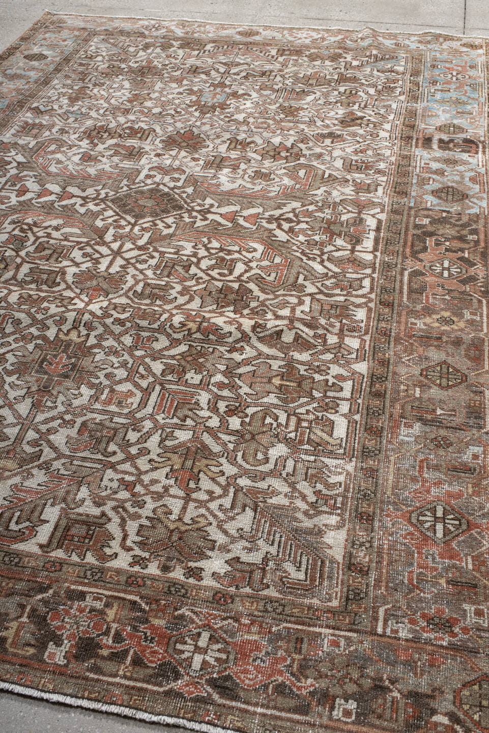 6' x 9' one-of-a-kind handmade antique Heriz medium size rug. Color palette: ivory, brown, sky_blue, rust, taupe, charcoal