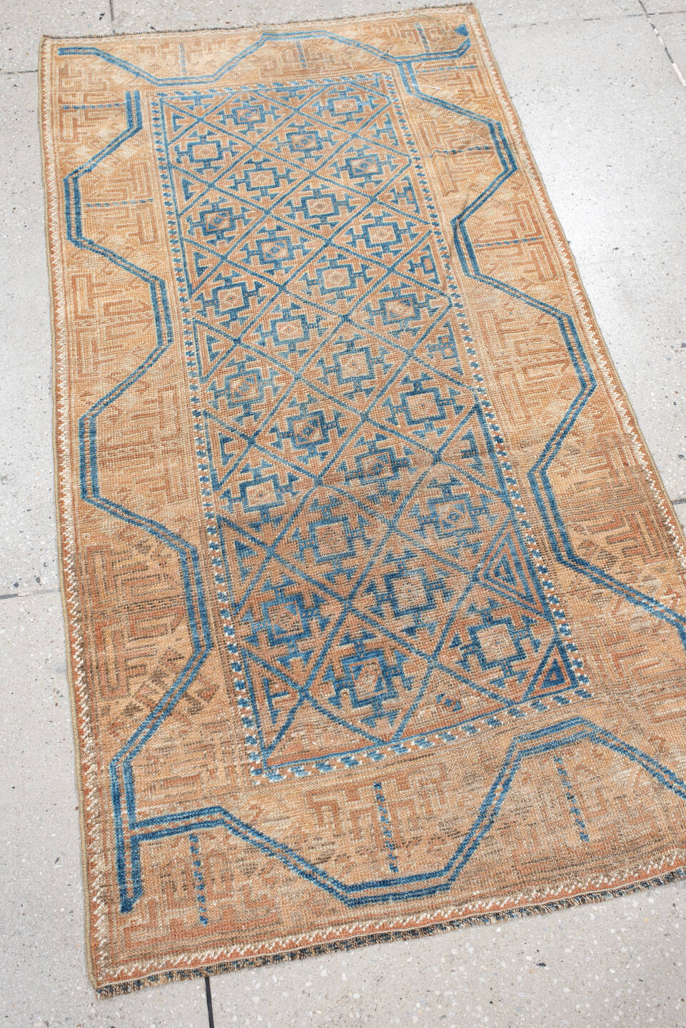 2' x 4' one-of-a-kind handmade antique Belouch small size rug. Color palette: peach, ivory, sky blue, camel, taupe