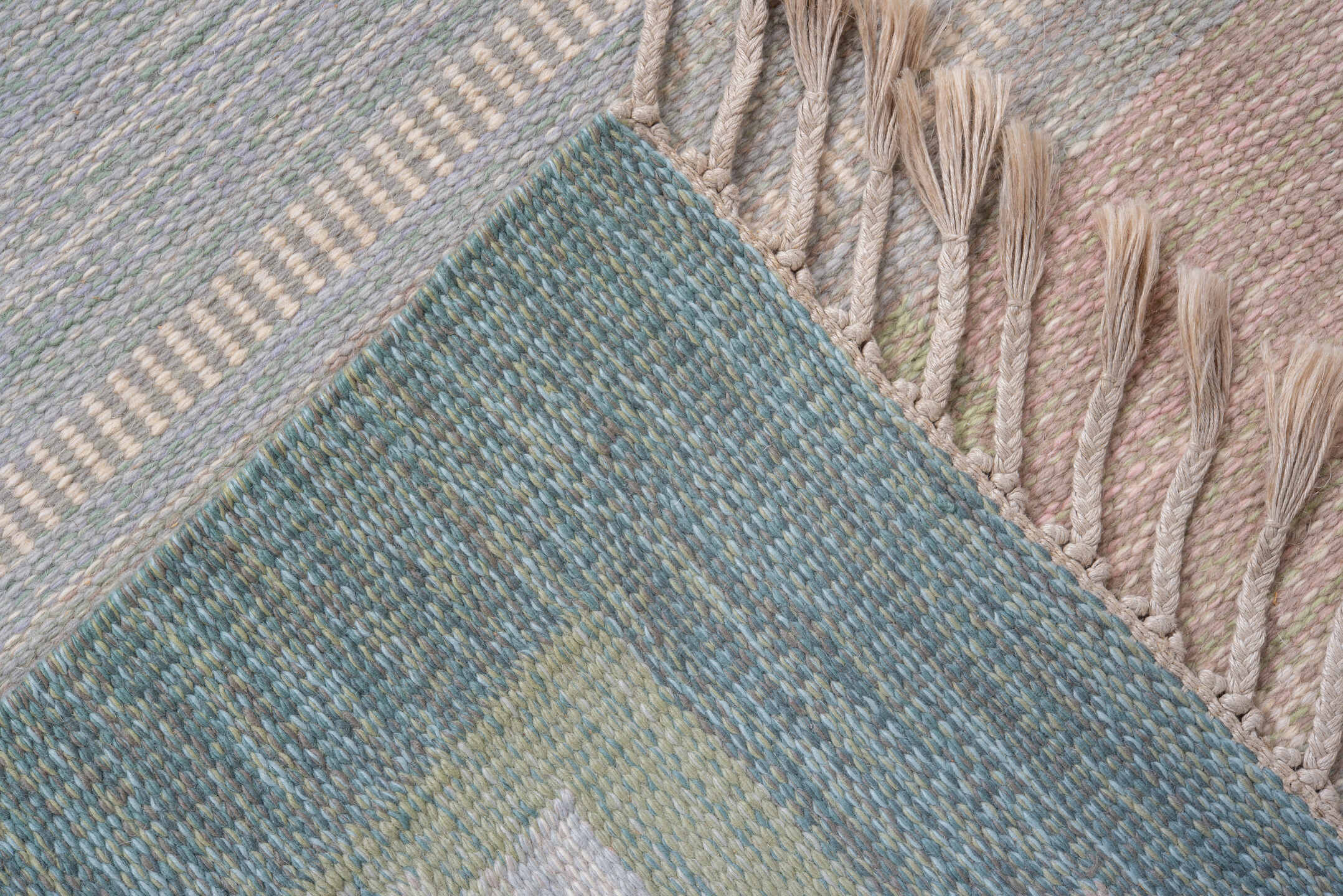 5' x 7' one-of-a-kind handmade antique Rollaken rug. Color palette: pale blue, seafoam, blush, ivory, sage, teal