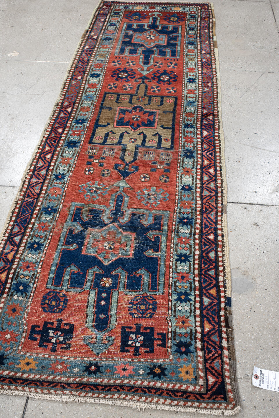 2' x 8' one-of-a-kind handmade vintage Heriz runner rug. Color palette: rust, navy, sky blue, ivory, camel, coral, charcoal