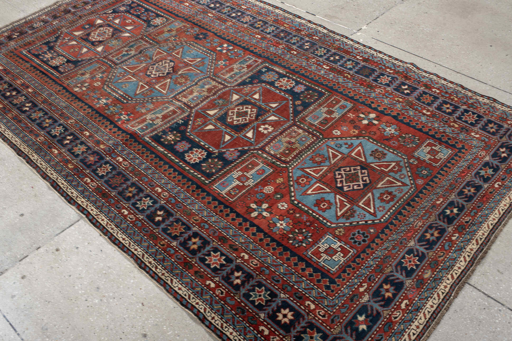 4' x 8' one-of-a-kind handmade vintage Shirvan rug. Color palette: rust, navy, sky blue, ivory, terra cotta, slate, cream