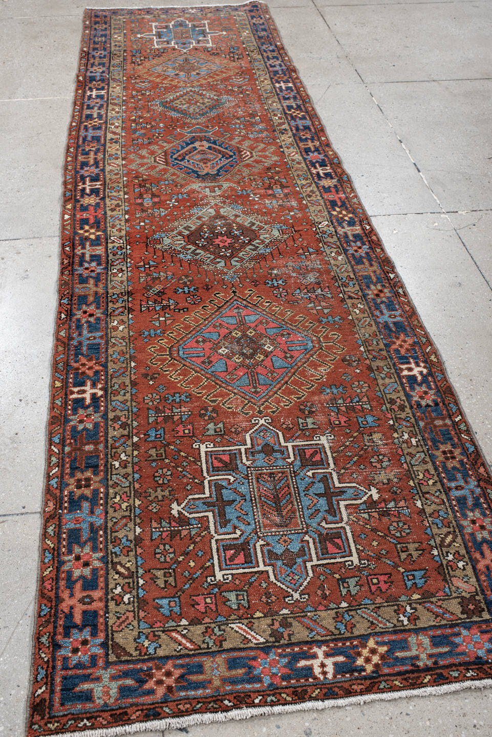 3' x 11' one-of-a-kind handmade vintage Karaje runner rug. Color palette: rust, indigo, sky_blue, ivory, camel, slate, rose