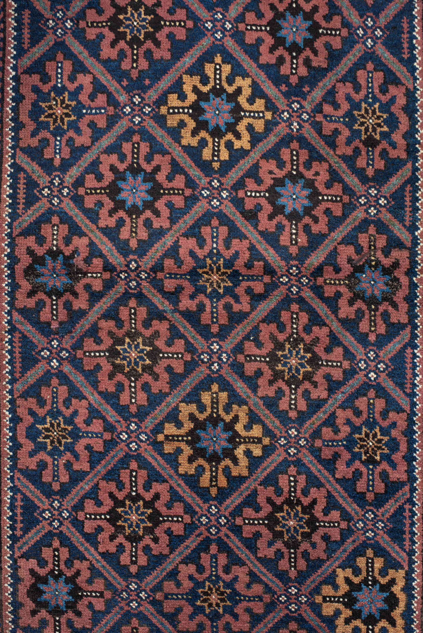 2' x 4' one-of-a-kind handmade vintage Belouch small size rug. Color palette: navy, camel, rust, indigo, gold, rose, ivory