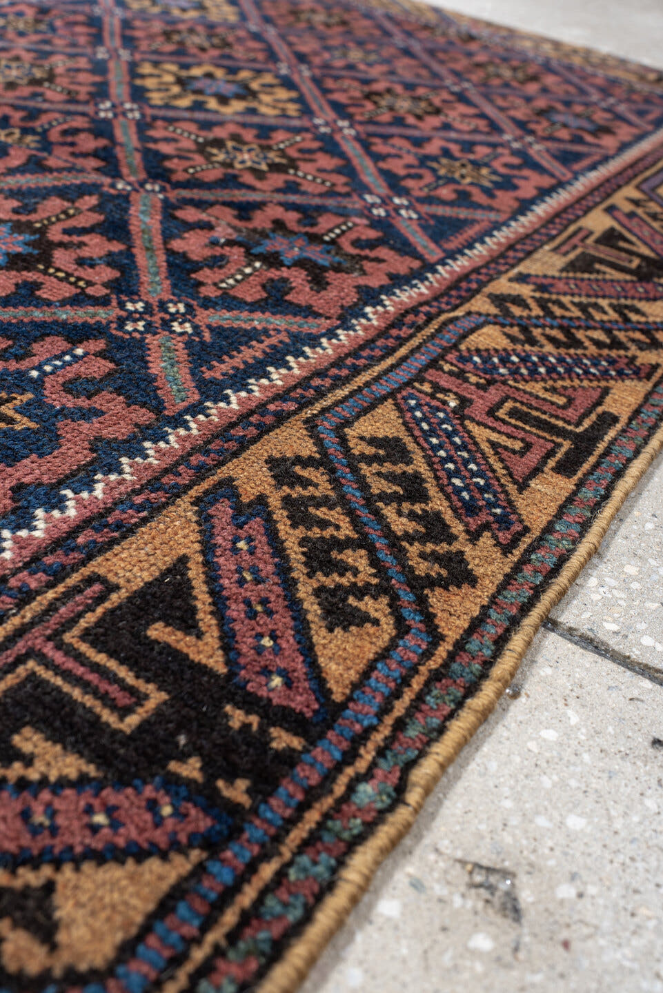2' x 4' one-of-a-kind handmade vintage Belouch small size rug. Color palette: navy, camel, rust, indigo, gold, rose, ivory