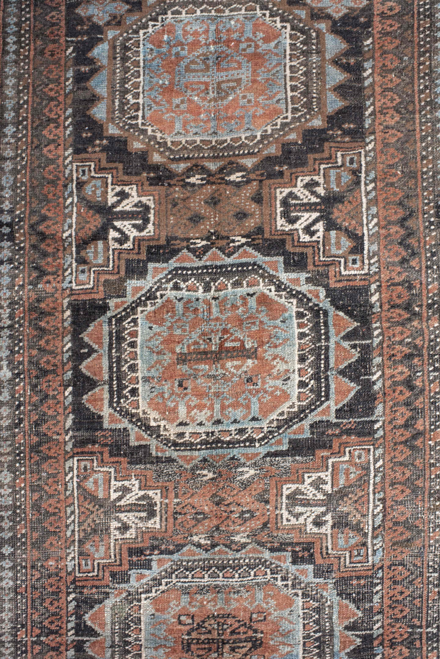 3' x 5' one-of-a-kind handmade antique Belouch small size rug. Color palette: brown, charcoal, rust, sky blue, ivory, taupe