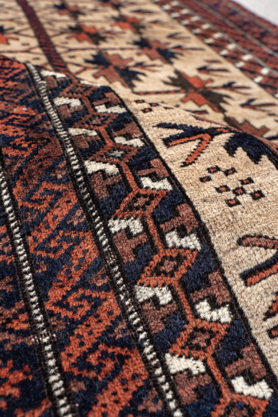 2' x 4' one-of-a-kind handmade vintage Belouch small size rug. Color palette: ivory, rust, navy, camel, brown, terracotta