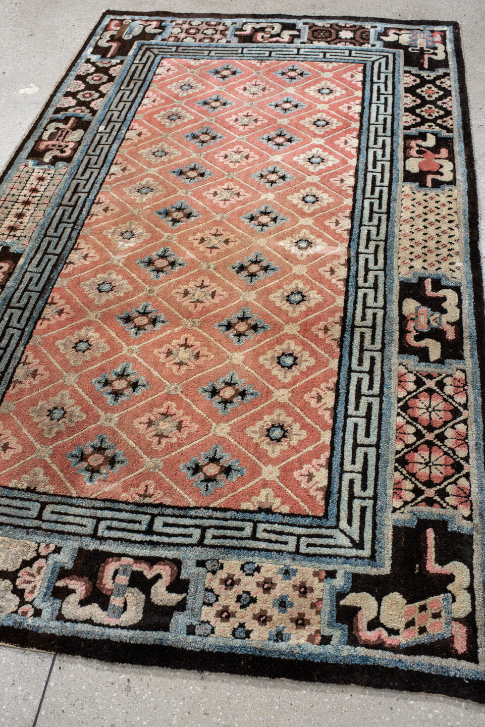 4' x 7' one-of-a-kind handmade vintage Tibetan rug. Color palette: salmon, charcoal, sky blue, ivory, rose, taupe, brown