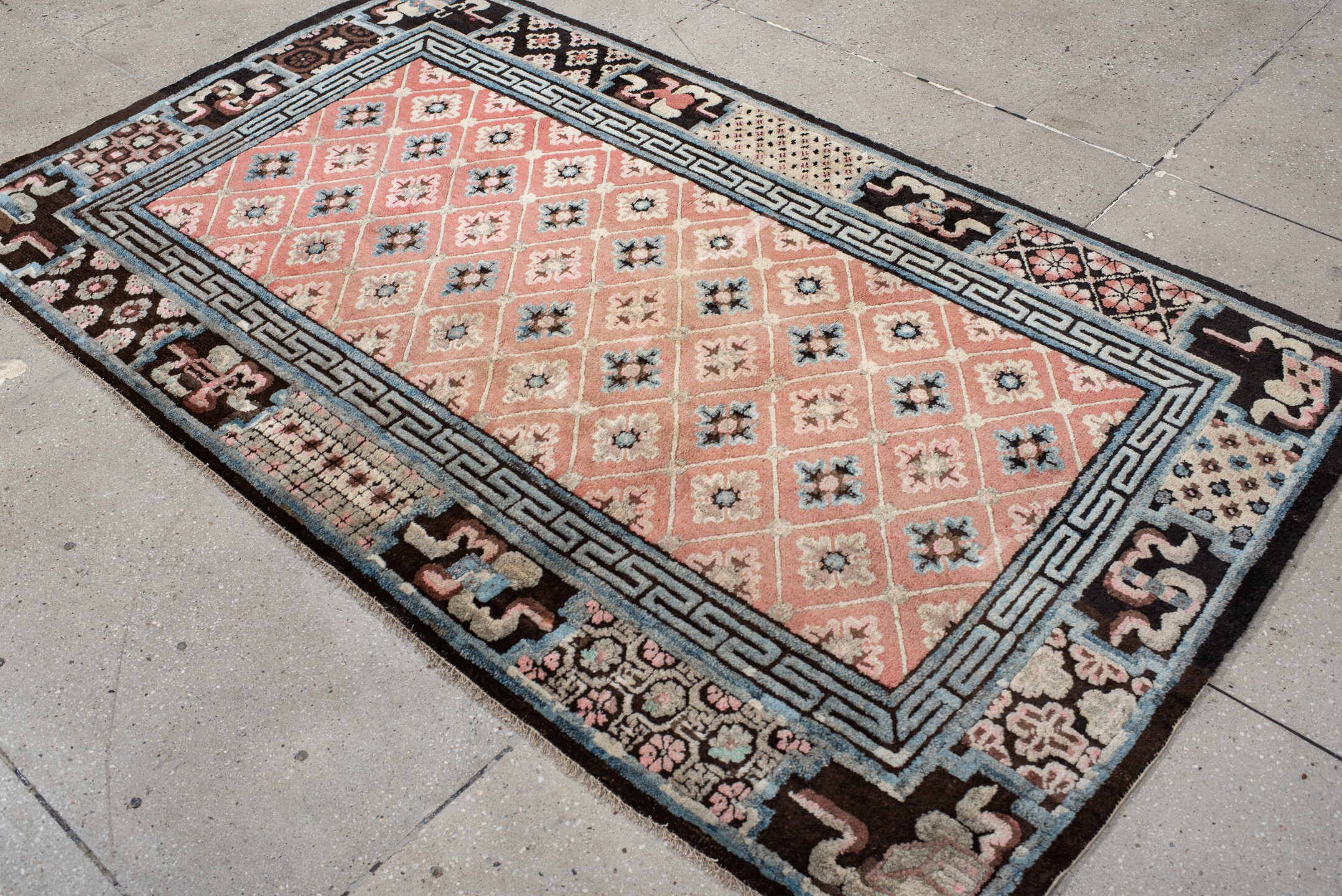 4' x 7' one-of-a-kind handmade vintage Tibetan rug. Color palette: salmon, charcoal, sky blue, ivory, rose, taupe, brown