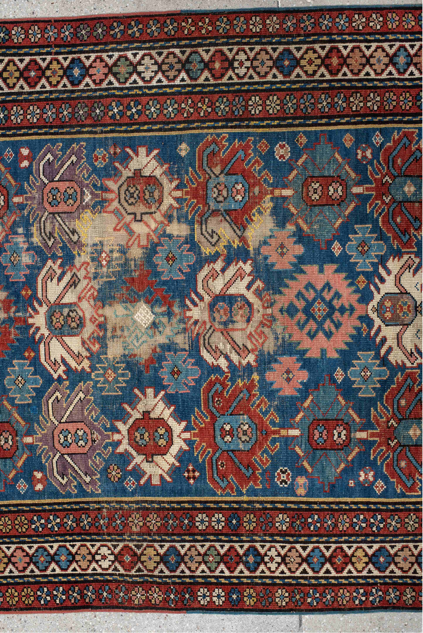 4' x 11' one-of-a-kind handmade vintage Caucasian runner rug. Color palette: arapawa, black, blue, brown, gray