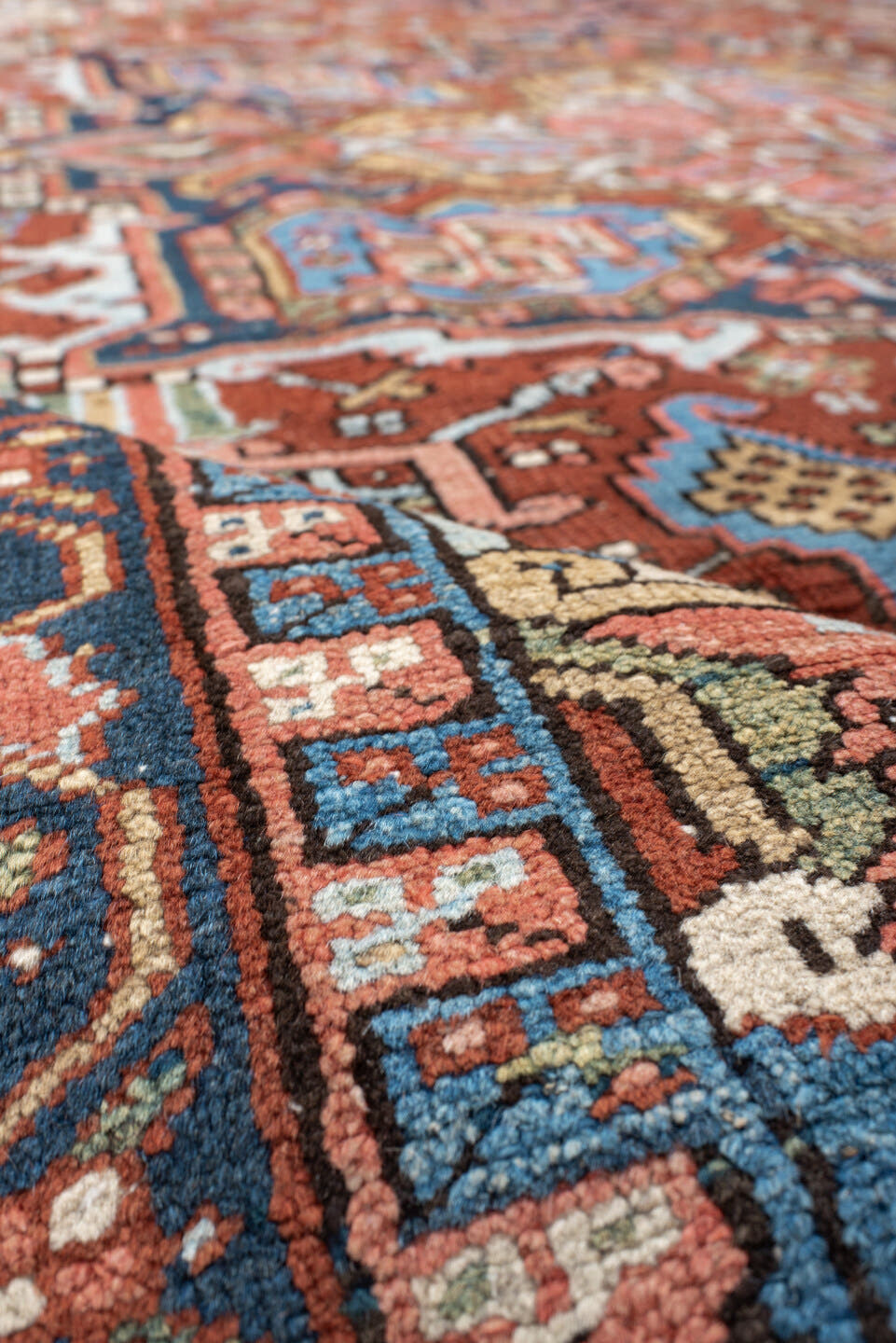 8' x 10' one-of-a-kind handmade antique Heriz large size rug. Color palette: rust, navy, ivory, sky blue, camel, coral, sage