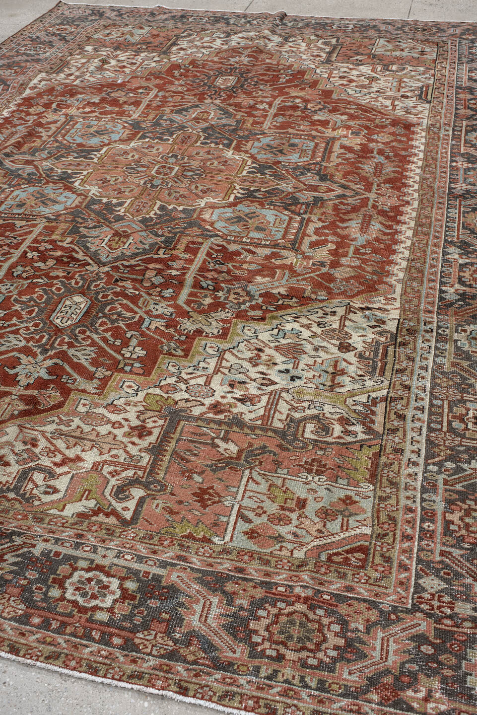 9' x 12' one-of-a-kind handmade antique Heriz large size rug. Color palette: rust, ivory, navy, terra cotta, sage, camel