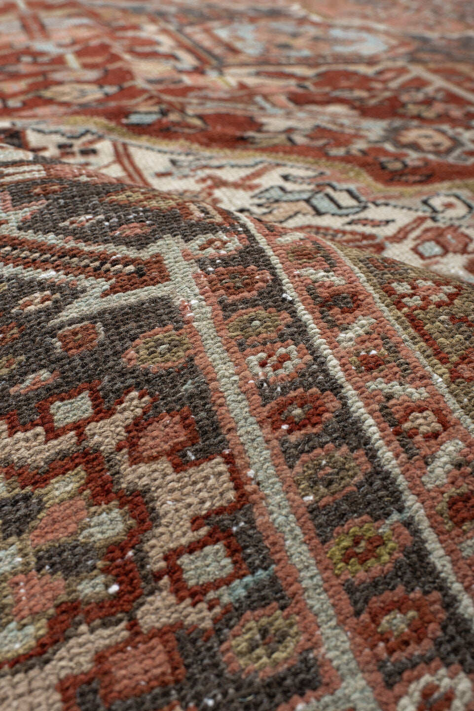 9' x 12' one-of-a-kind handmade antique Heriz large size rug. Color palette: rust, ivory, navy, terra cotta, sage, camel
