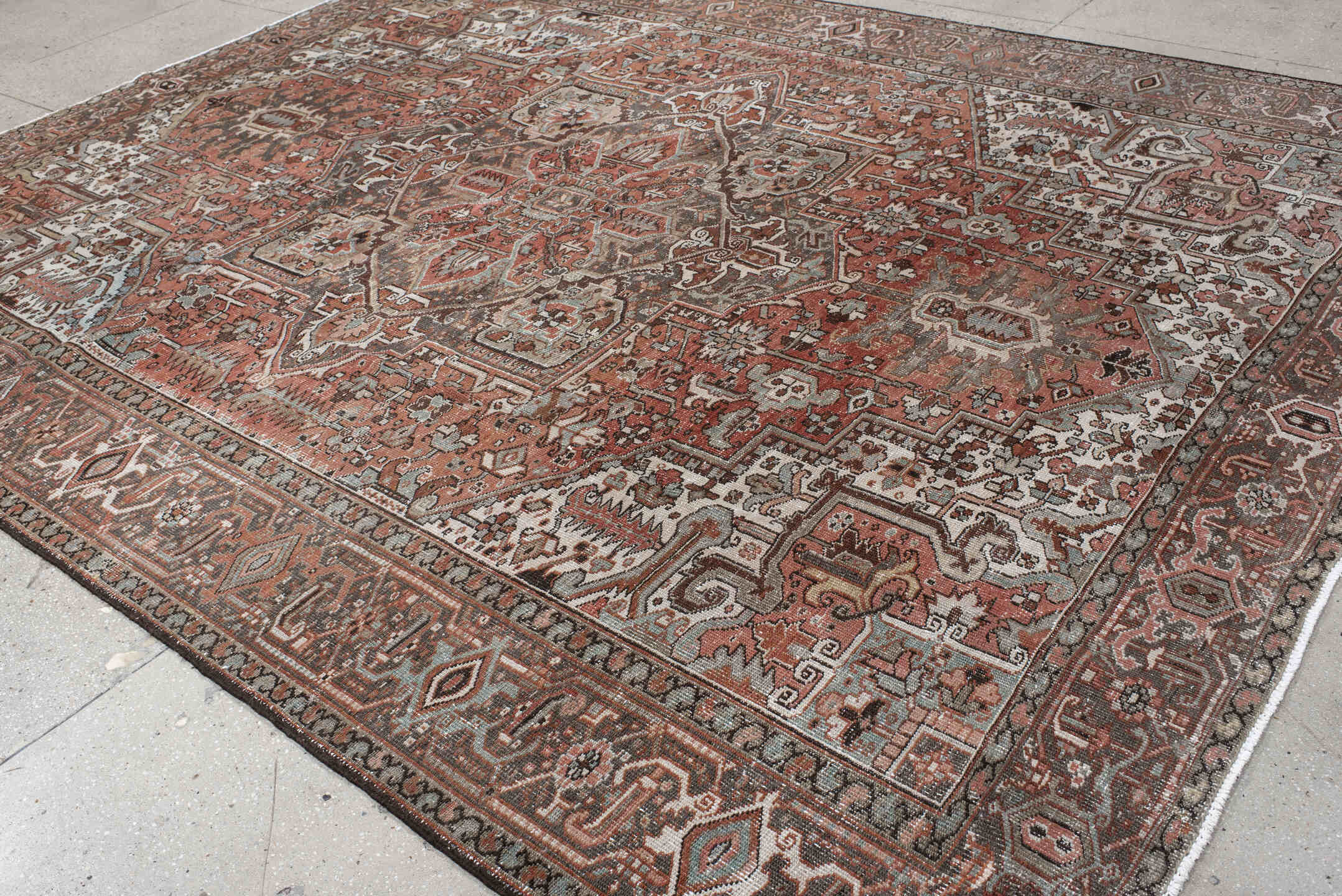 9' x 12' one-of-a-kind handmade antique Heriz large size rug. Color palette: rust, ivory, charcoal, taupe, terra cotta