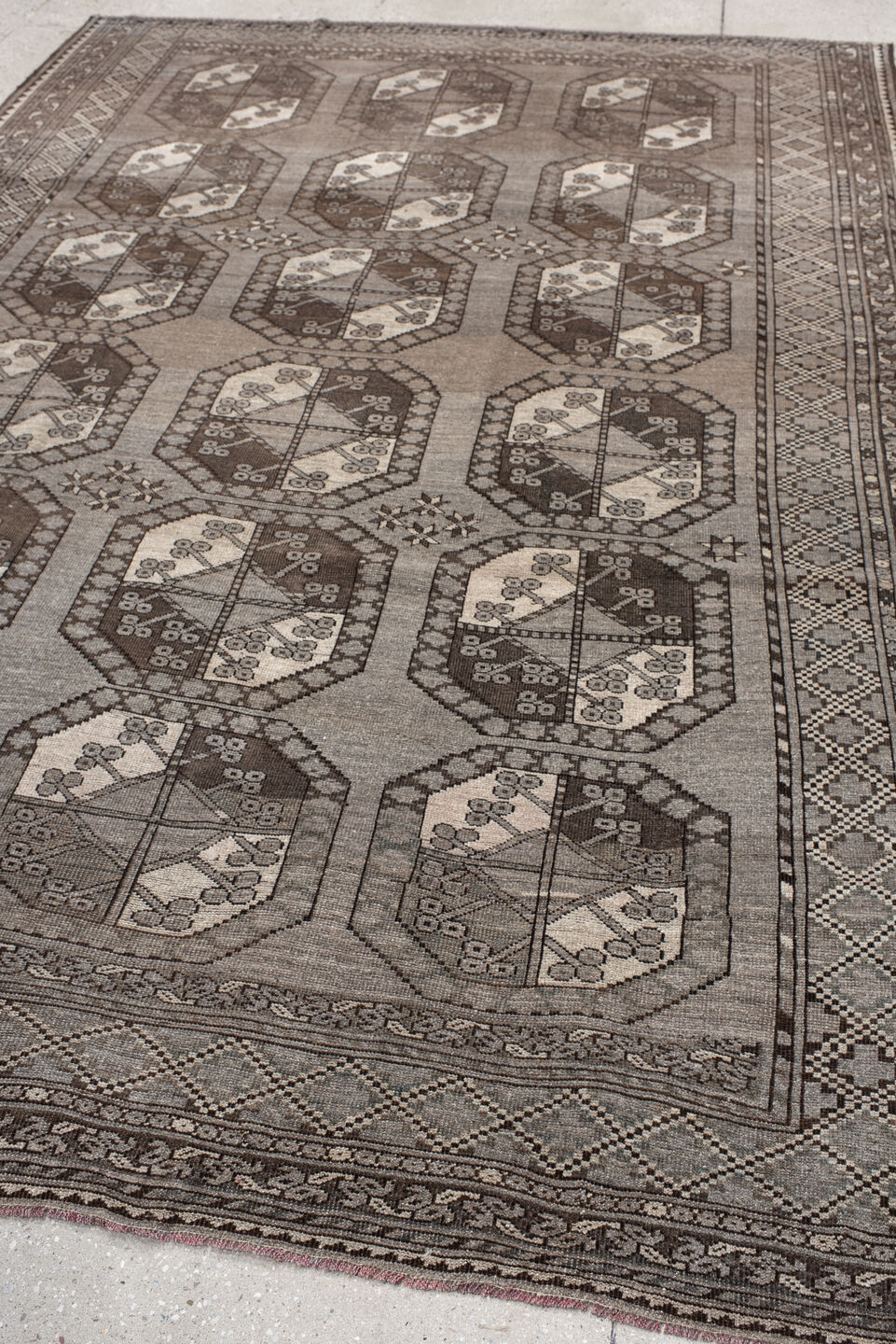 7' x 10' one-of-a-kind handmade vintage Afghan large size rug. Color palette: black, brown, gray, light gray, off-white