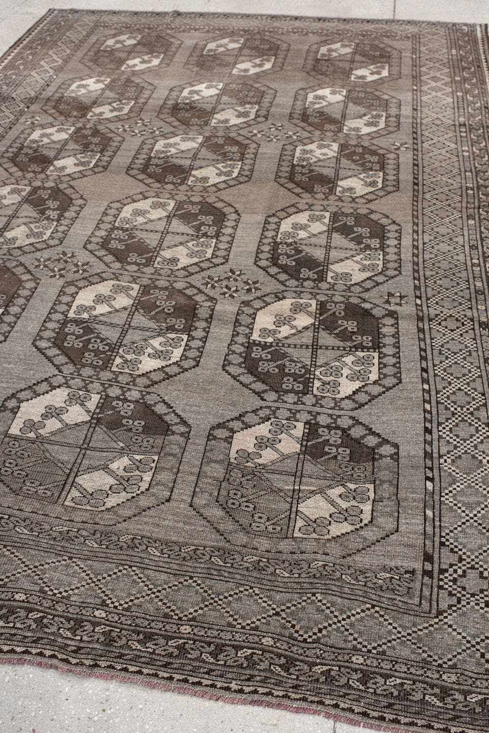 7' x 10' one-of-a-kind handmade antique Afghan large size rug. Color palette: taupe, brown, ivory, charcoal, camel, beige