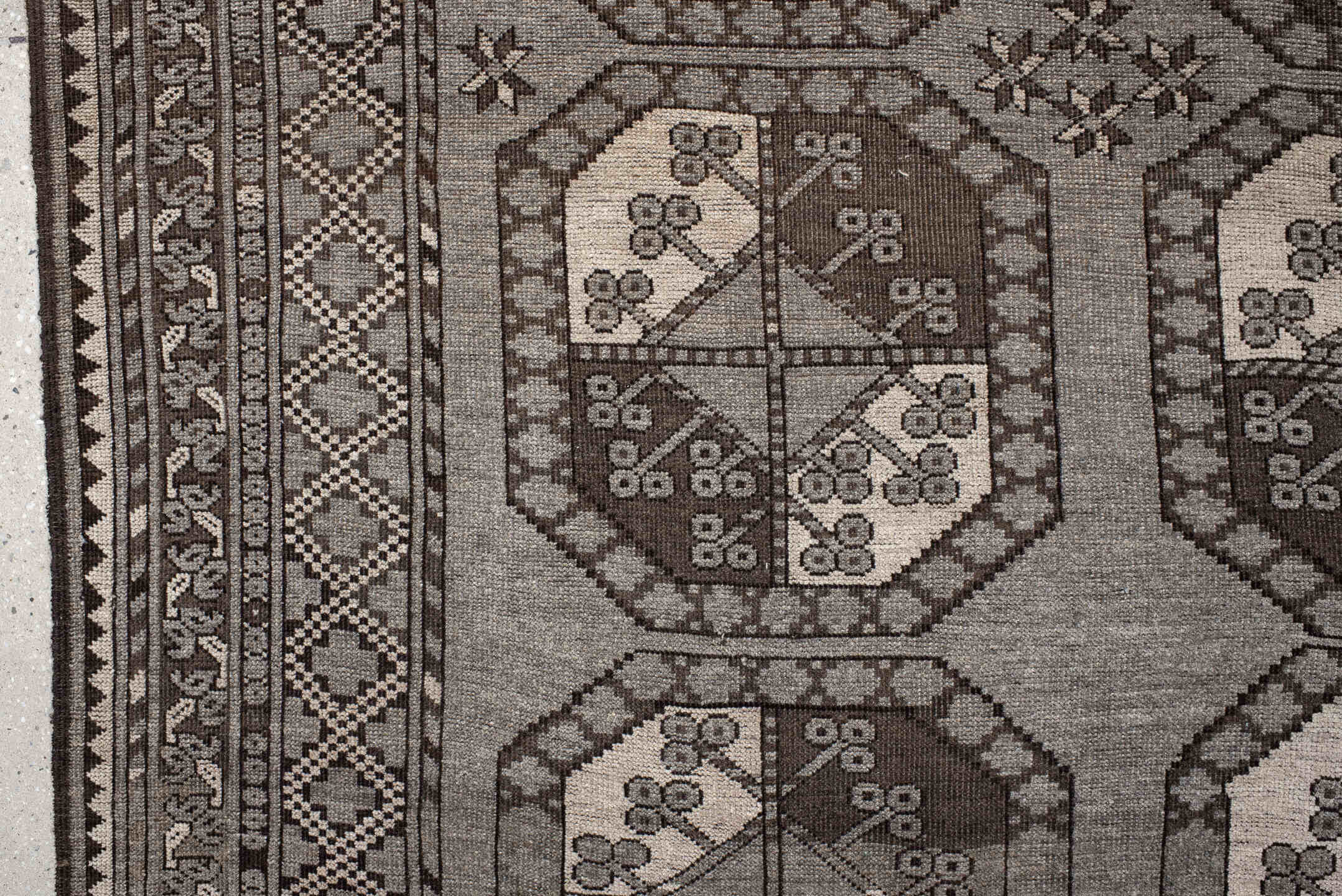 7' x 10' one-of-a-kind handmade vintage Afghan large size rug. Color palette: black, brown, gray, light gray, off-white