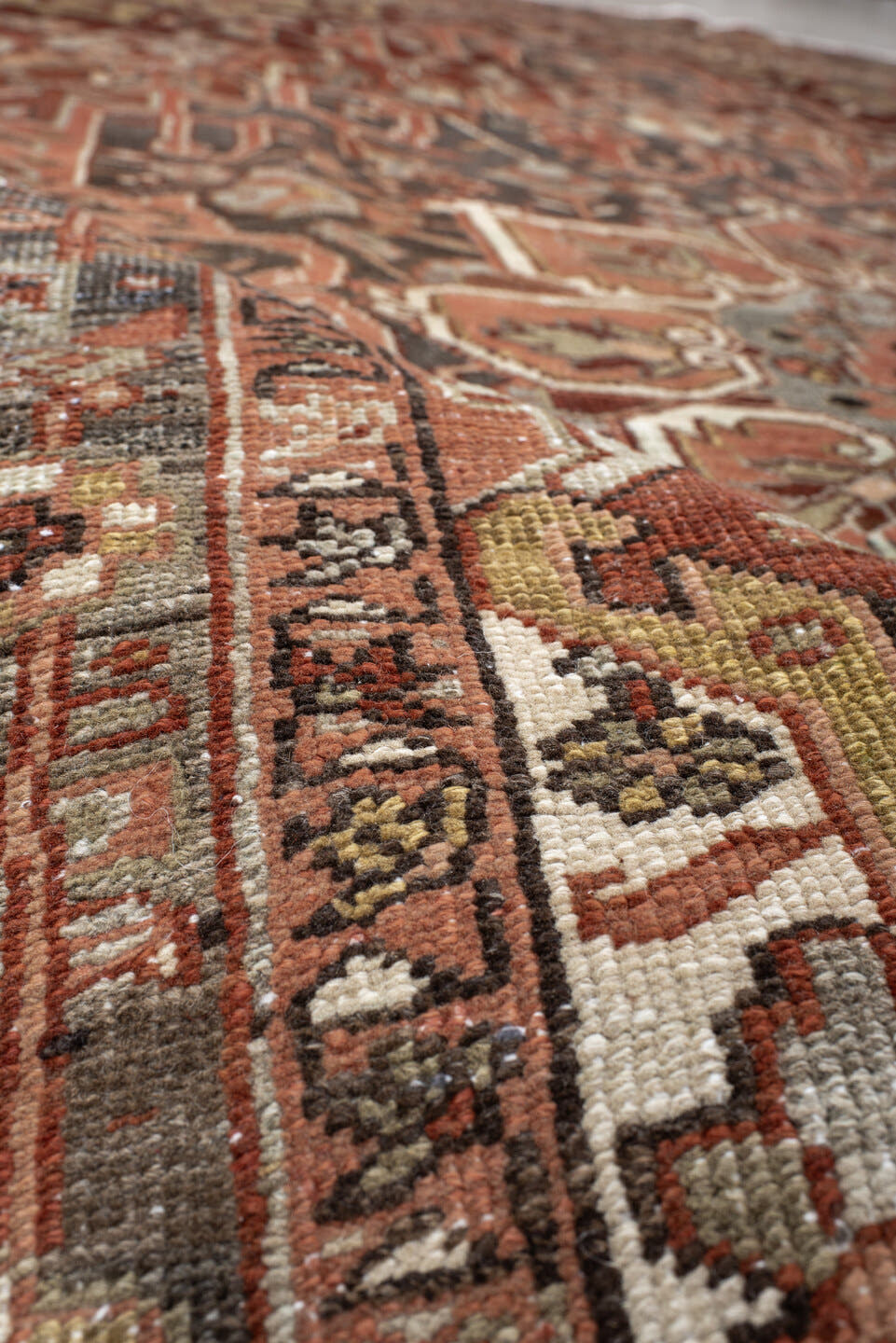7' x 11' one-of-a-kind handmade antique Heriz large size rug. Color palette: rust, brick, slate, ivory, camel, taupe