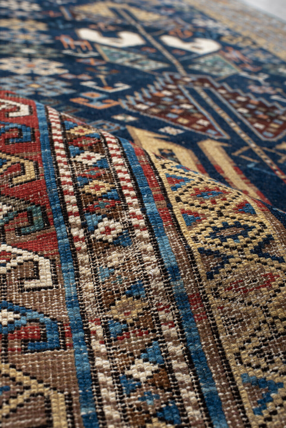 3' x 9' one-of-a-kind handmade vintage Shirvan runner rug. Color palette: navy, camel, ivory, sky blue, taupe, rust, sage
