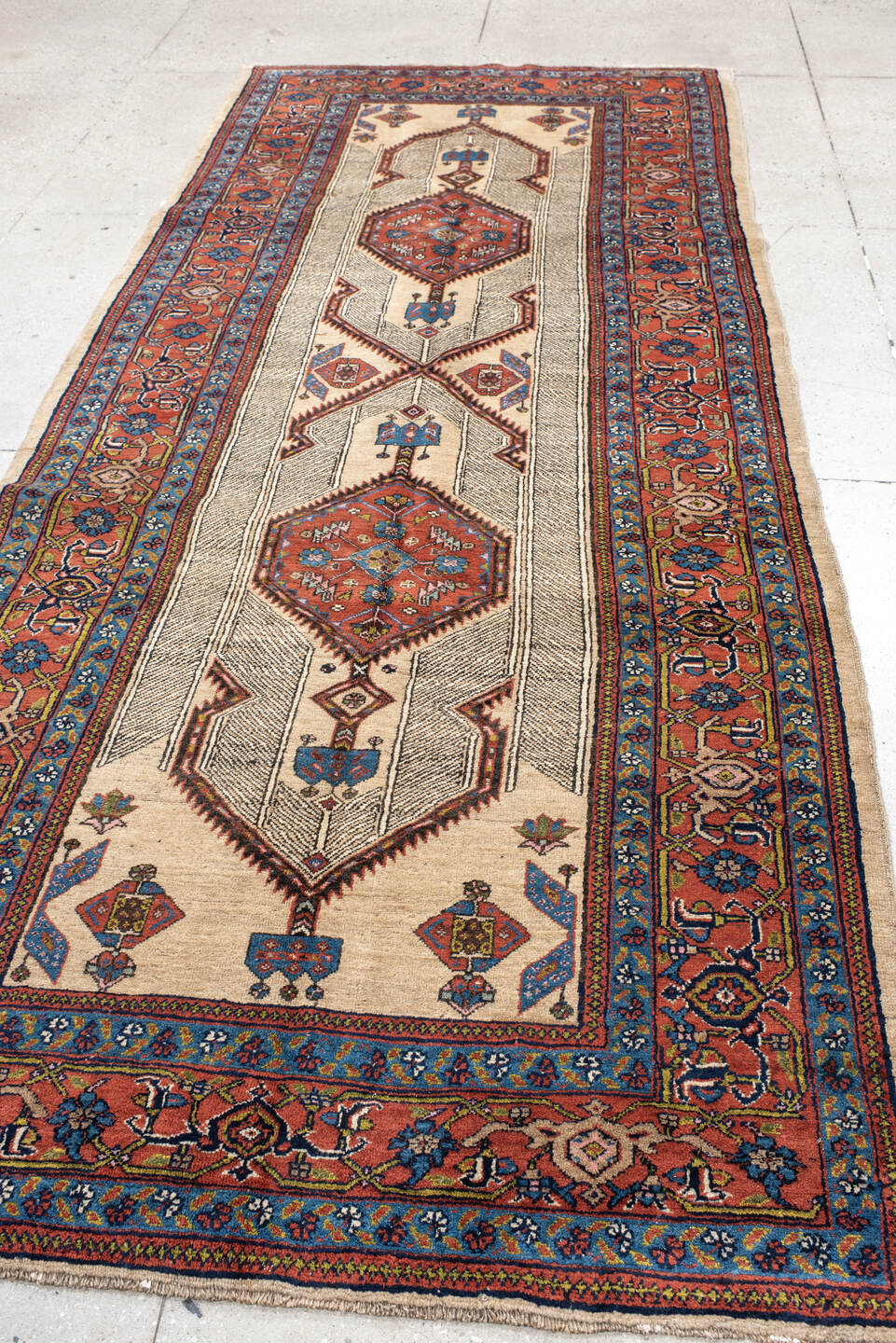 4' x 11' one-of-a-kind handmade antique Sarab runner rug. Color palette: ivory, rust, indigo, navy, crimson, camel, saffron