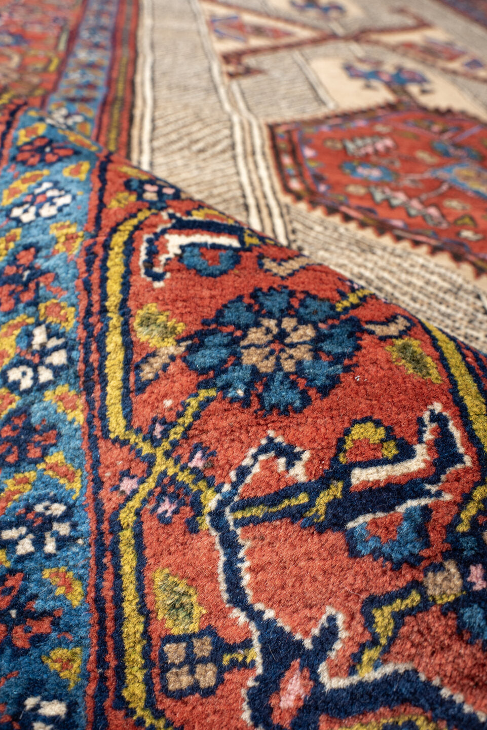 4' x 11' one-of-a-kind handmade antique Sarab runner rug. Color palette: ivory, rust, indigo, navy, crimson, camel, saffron