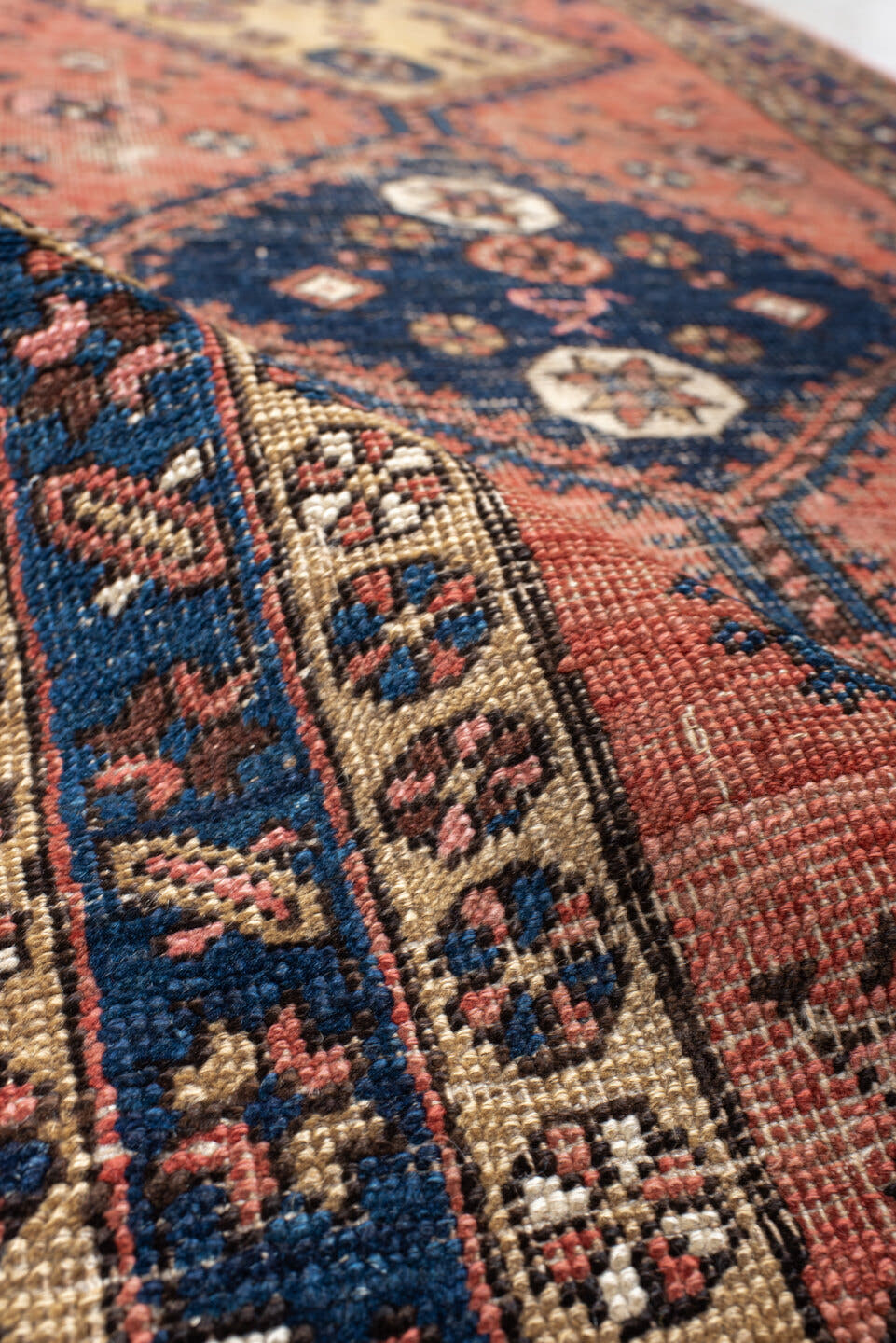 3' x 6' one-of-a-kind handmade antique runner rug. Color palette: rose, indigo, ivory, rust, navy, camel, crimson, pink