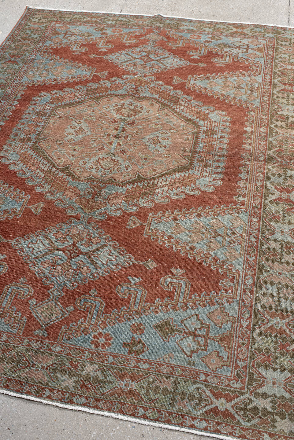 5' x 6' one-of-a-kind handmade vintage Veece rug. Color palette: terra cotta, pale blue, sage, ivory, rose, olive