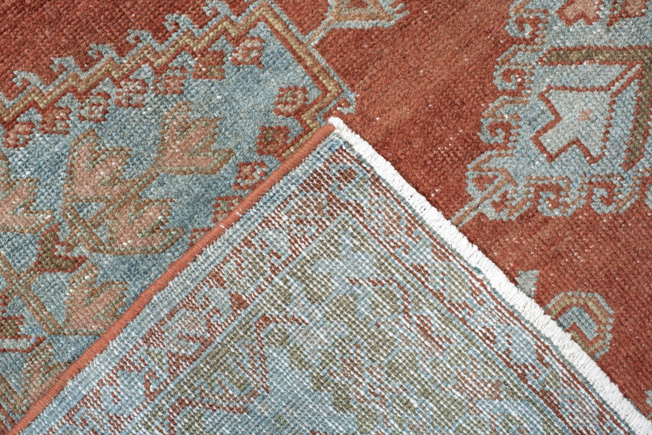 5' x 6' one-of-a-kind handmade vintage Veece rug. Color palette: terra cotta, pale blue, sage, ivory, rose, olive