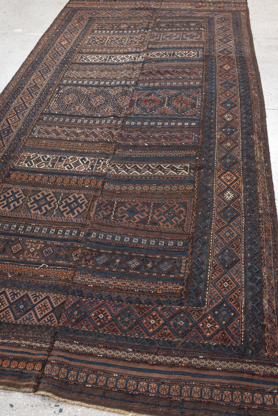 5' x 11' one-of-a-kind handmade vintage Kilim rug. Color palette: brown, indigo, rust, camel, ivory, charcoal, purple