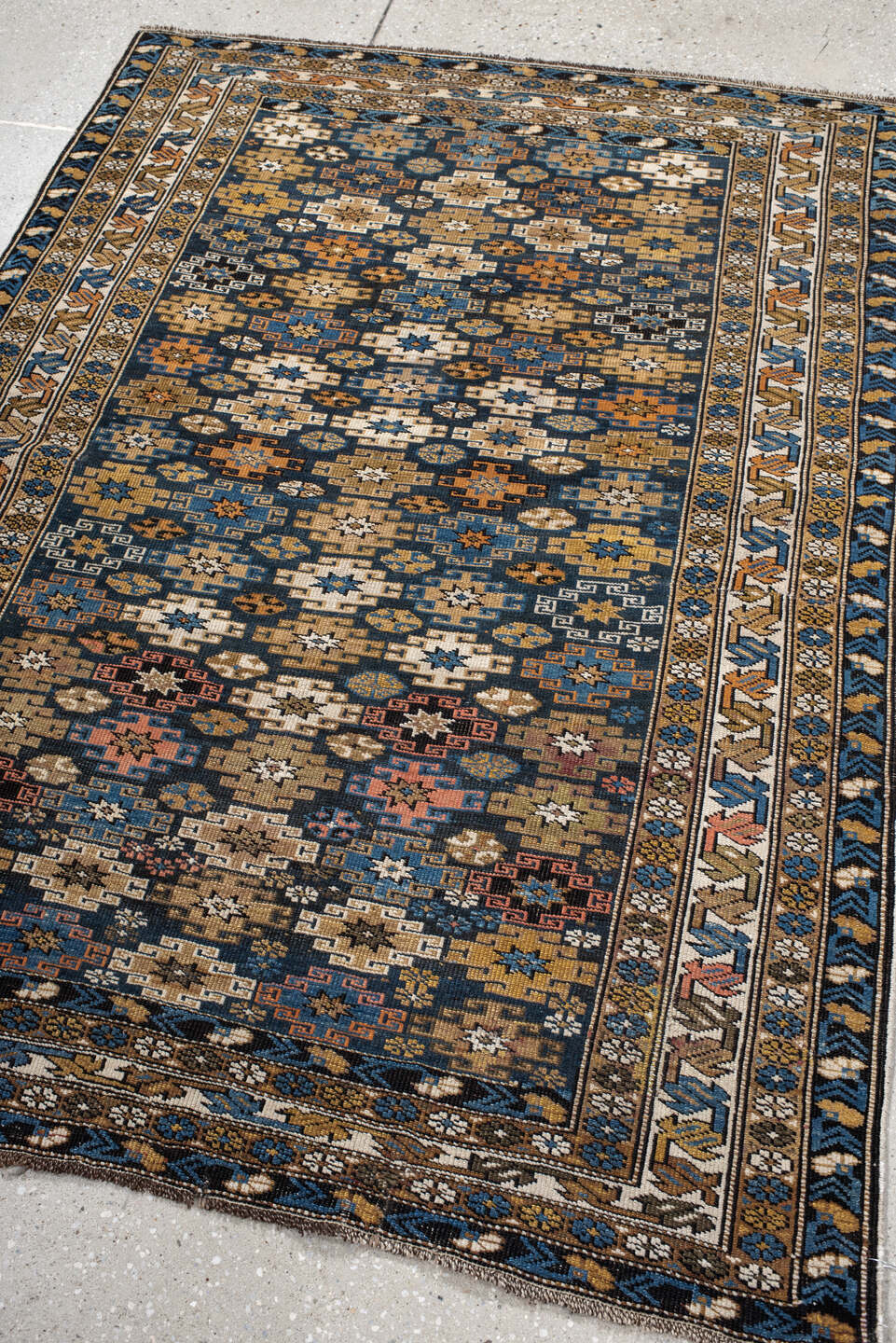 3' x 5' one-of-a-kind handmade vintage Caucasian small size rug. Color palette: navy, camel, ivory, sky blue, rust, brown