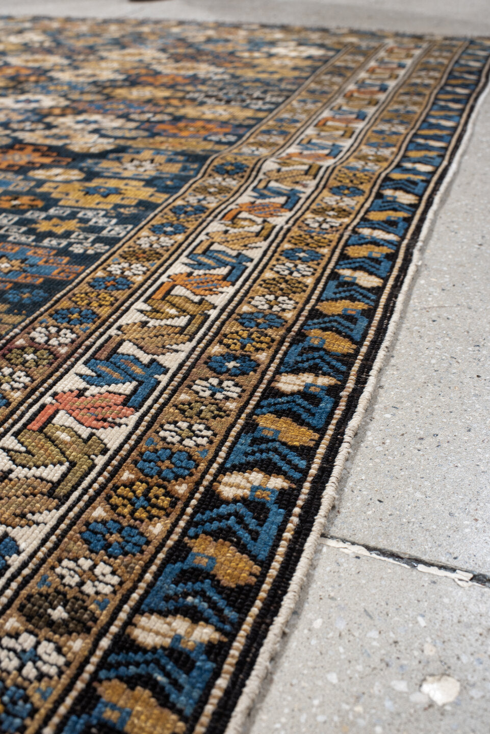 3' x 5' one-of-a-kind handmade vintage Caucasian small size rug. Color palette: navy, camel, ivory, sky blue, rust, brown