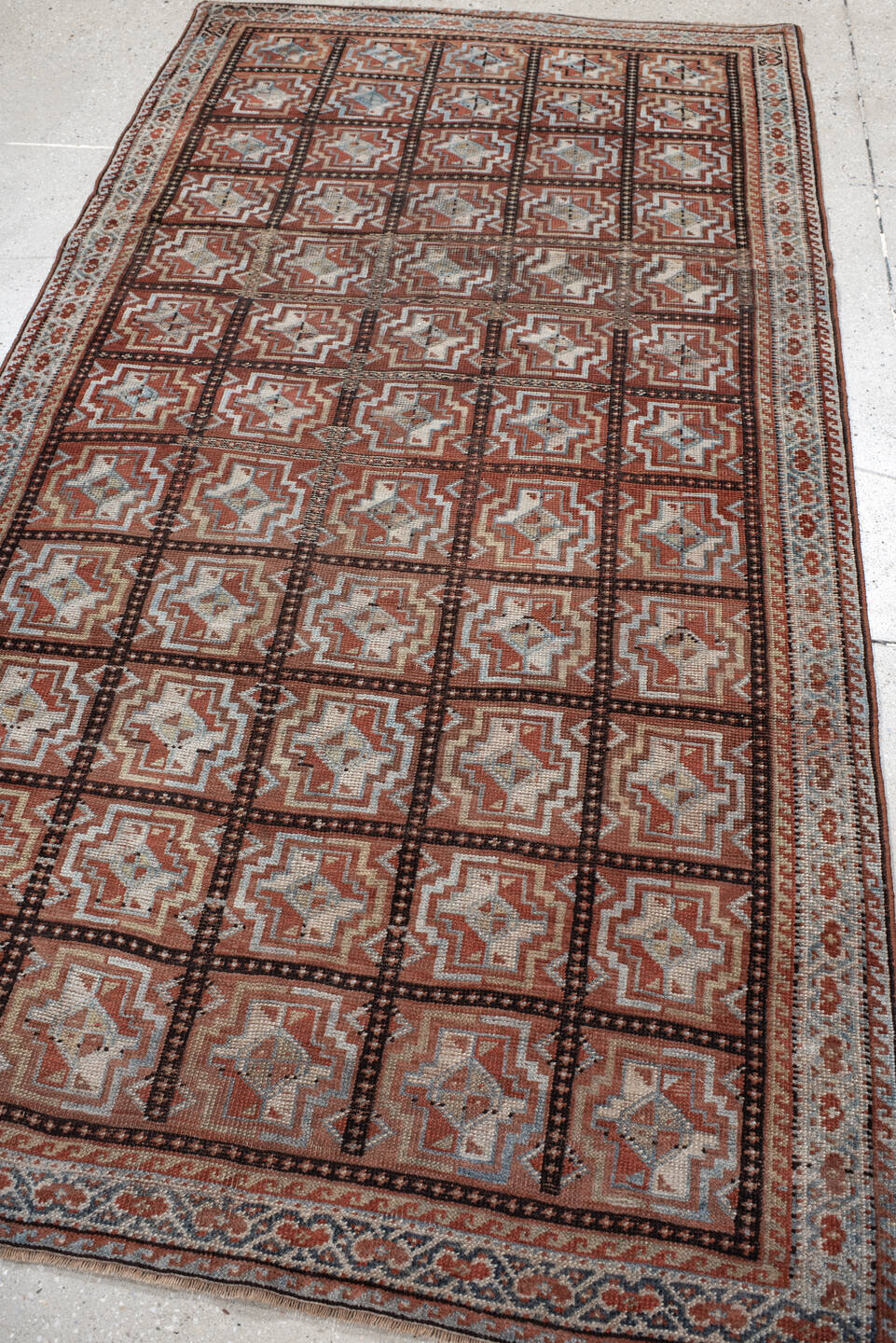 3' x 7' one-of-a-kind handmade vintage Kurd rug. Color palette: rust, ivory, light blue, charcoal, terracotta, camel, brown