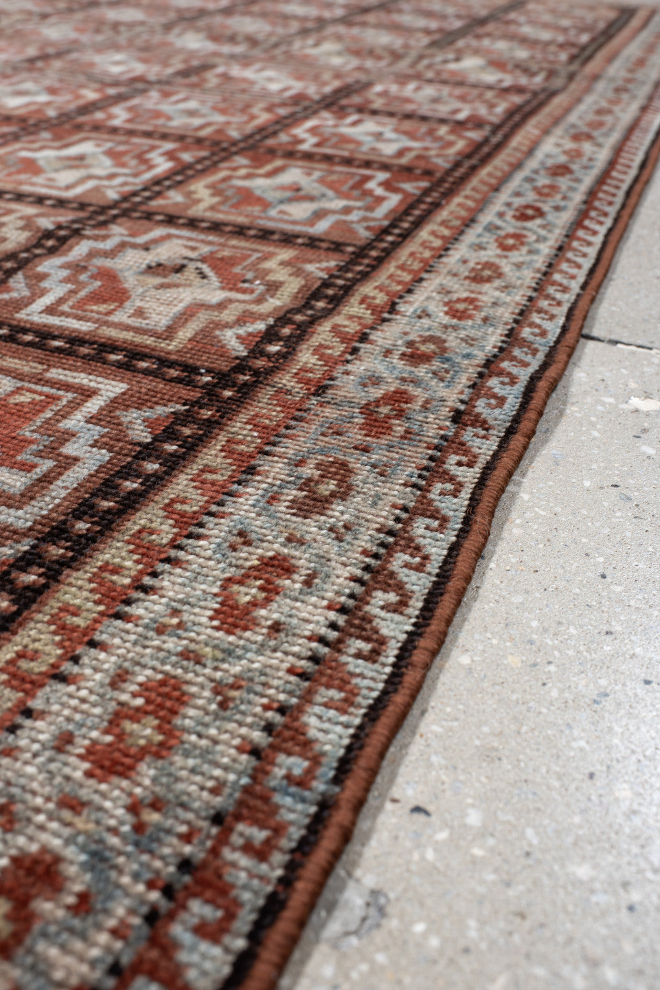 3' x 7' one-of-a-kind handmade vintage Kurd rug. Color palette: rust, ivory, light blue, charcoal, terracotta, camel, brown
