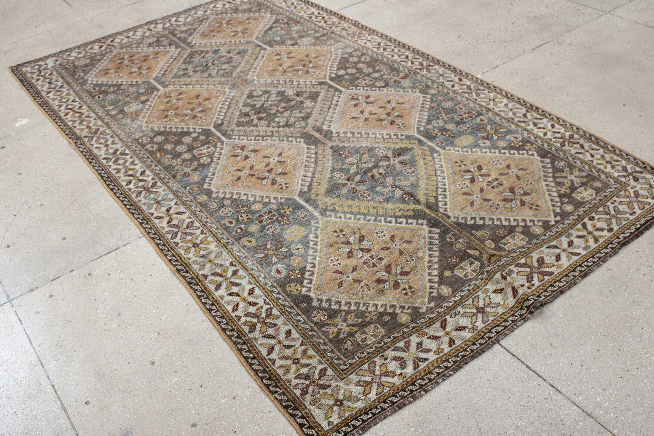 4' x 8' one-of-a-kind handmade vintage Shiraz rug. Color palette: slate, ivory, camel, taupe, rust, charcoal, sage, gold