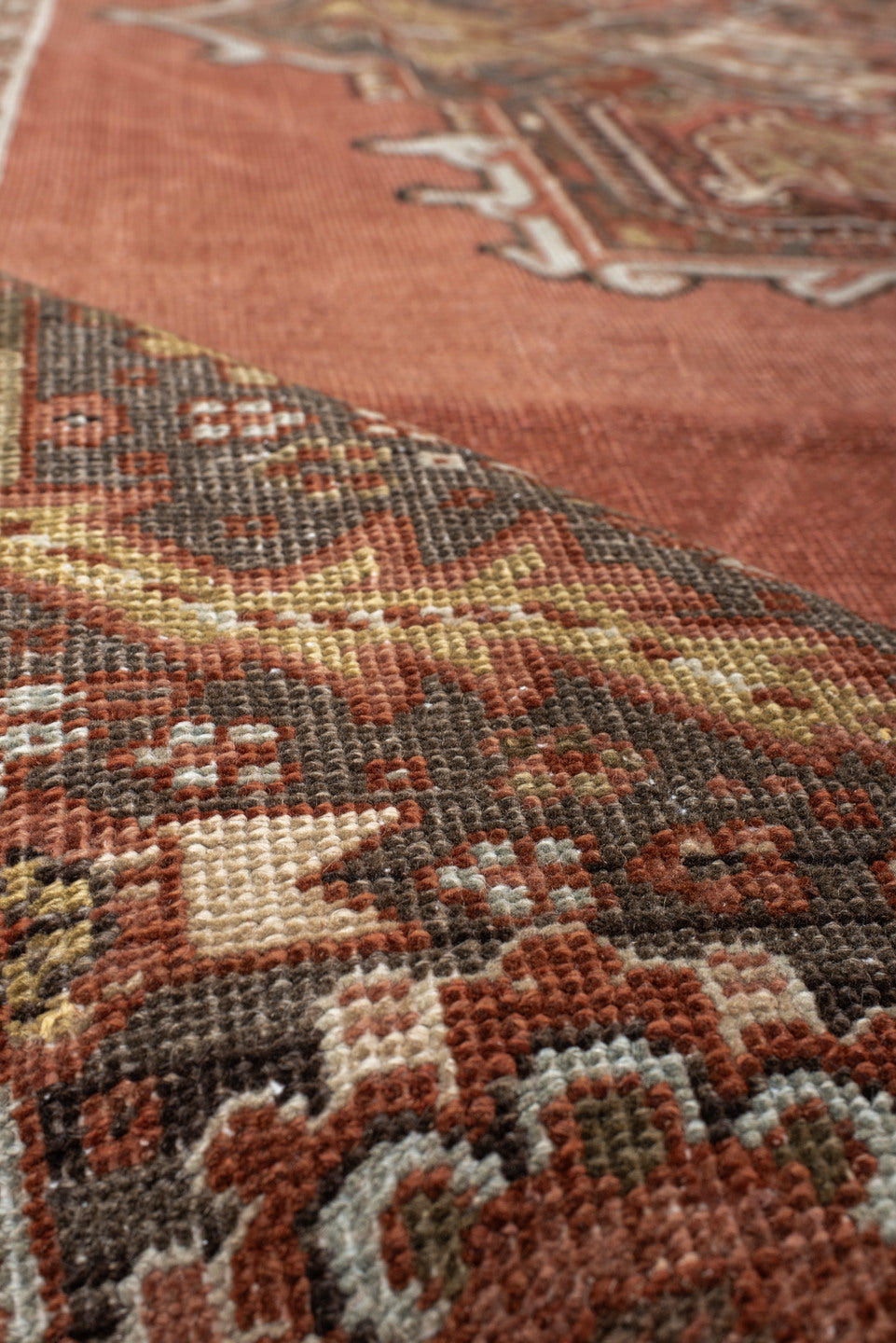 8' x 11' one-of-a-kind handmade antique Heriz large size rug. Color palette: terra cotta, ivory, charcoal, rust, sage, taupe