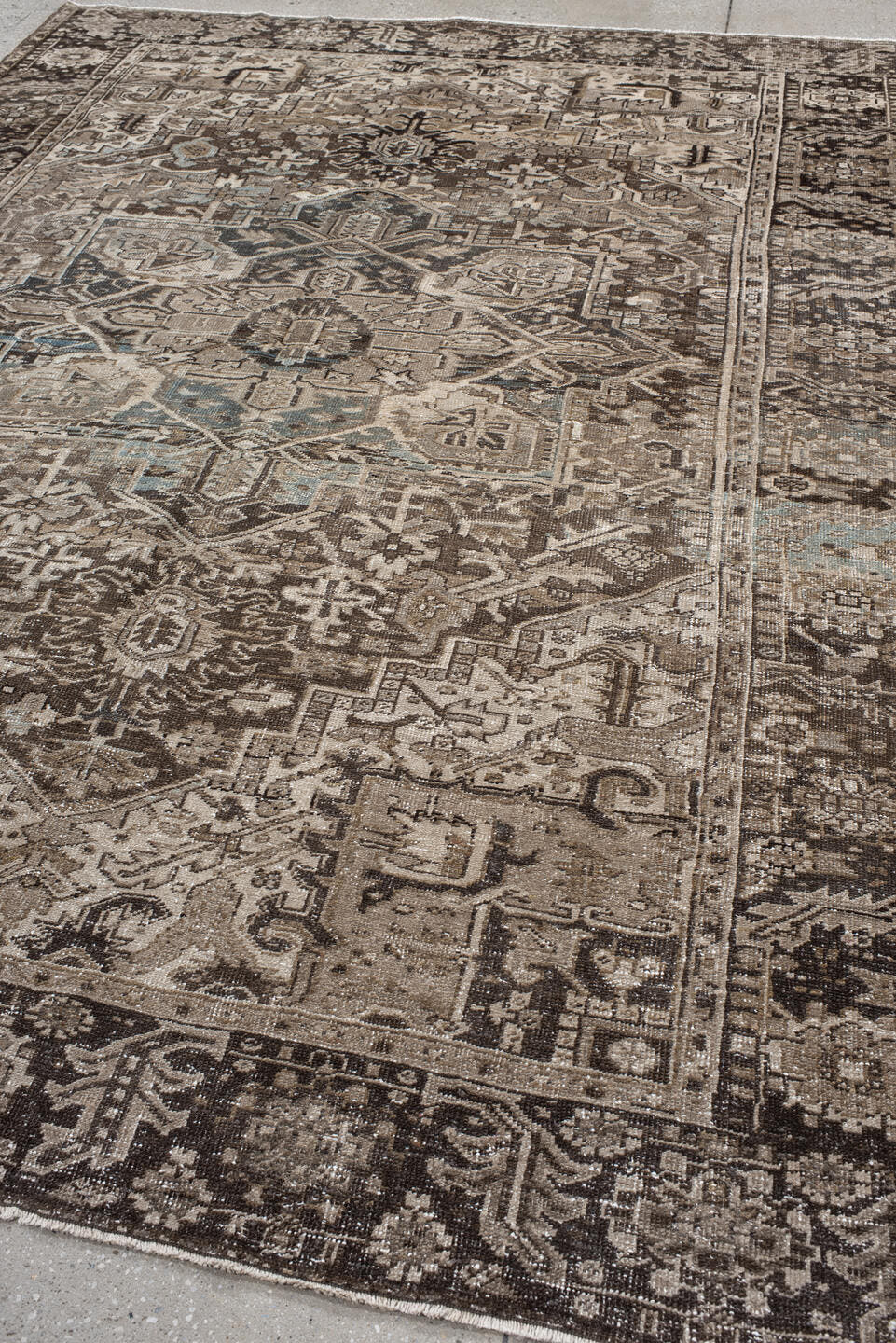 7' x 10' one-of-a-kind handmade antique Heriz large size rug. Color palette: taupe, brown, ivory, charcoal, faded blue