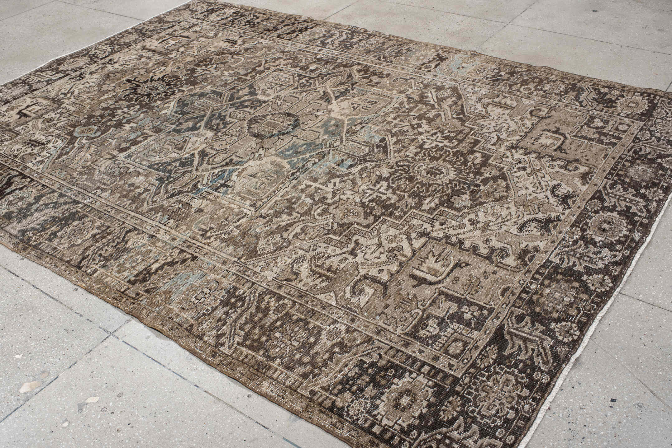 7' x 10' one-of-a-kind handmade antique Heriz large size rug. Color palette: taupe, brown, ivory, charcoal, faded blue