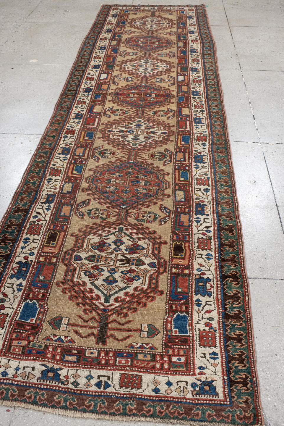 3' x 13' one-of-a-kind handmade vintage Sarab runner rug. Color palette: ivory, rust, indigo, teal, camel, crimson, brown
