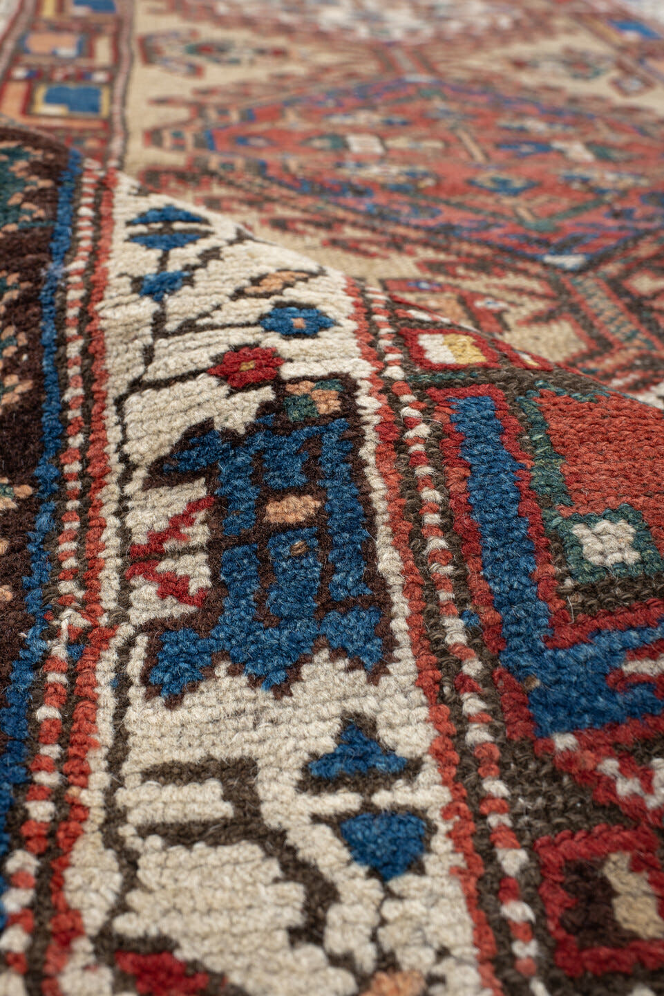 3' x 13' one-of-a-kind handmade vintage Sarab runner rug. Color palette: ivory, rust, indigo, teal, camel, crimson, brown