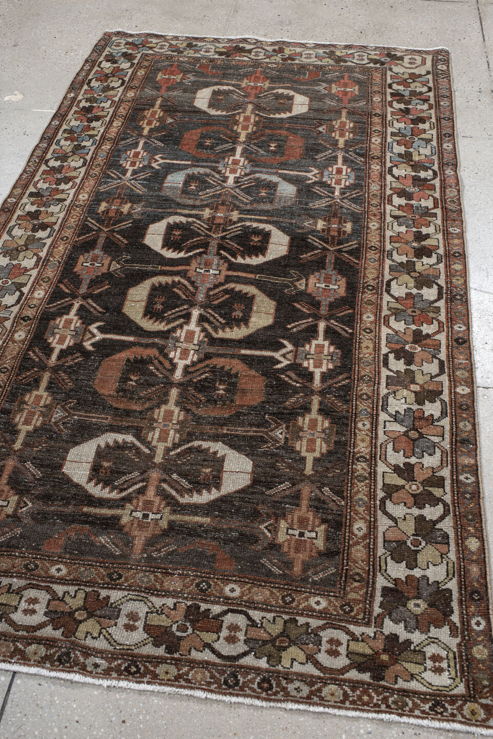 4' x 7' one-of-a-kind handmade antique Shirvan rug. Color palette: charcoal, ivory, rust, taupe, slate, camel, terracotta