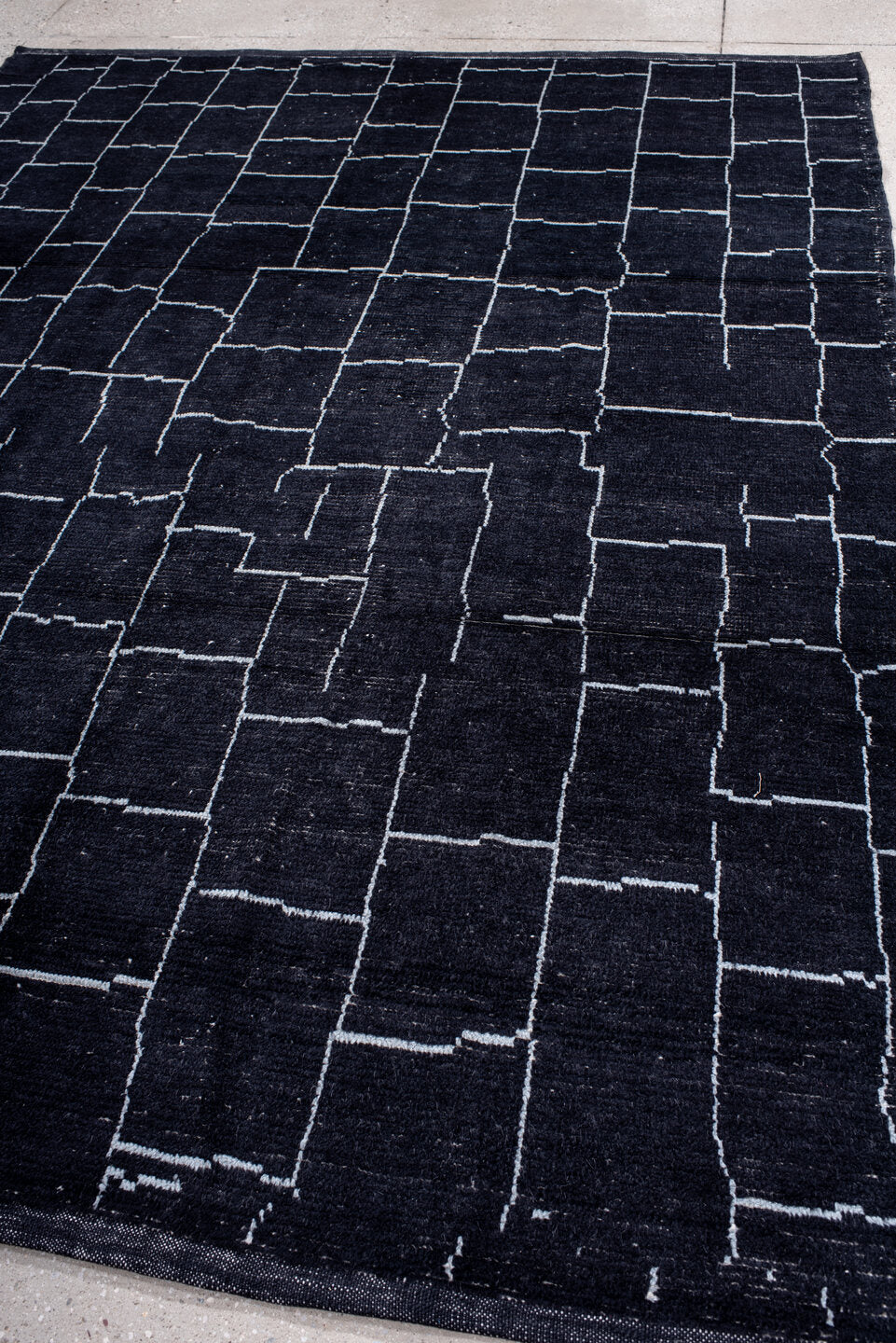 7' x 9' one-of-a-kind handmade vintage Moroccan rug. Color palette: black, blue, gray, lavender, light blue, light gray