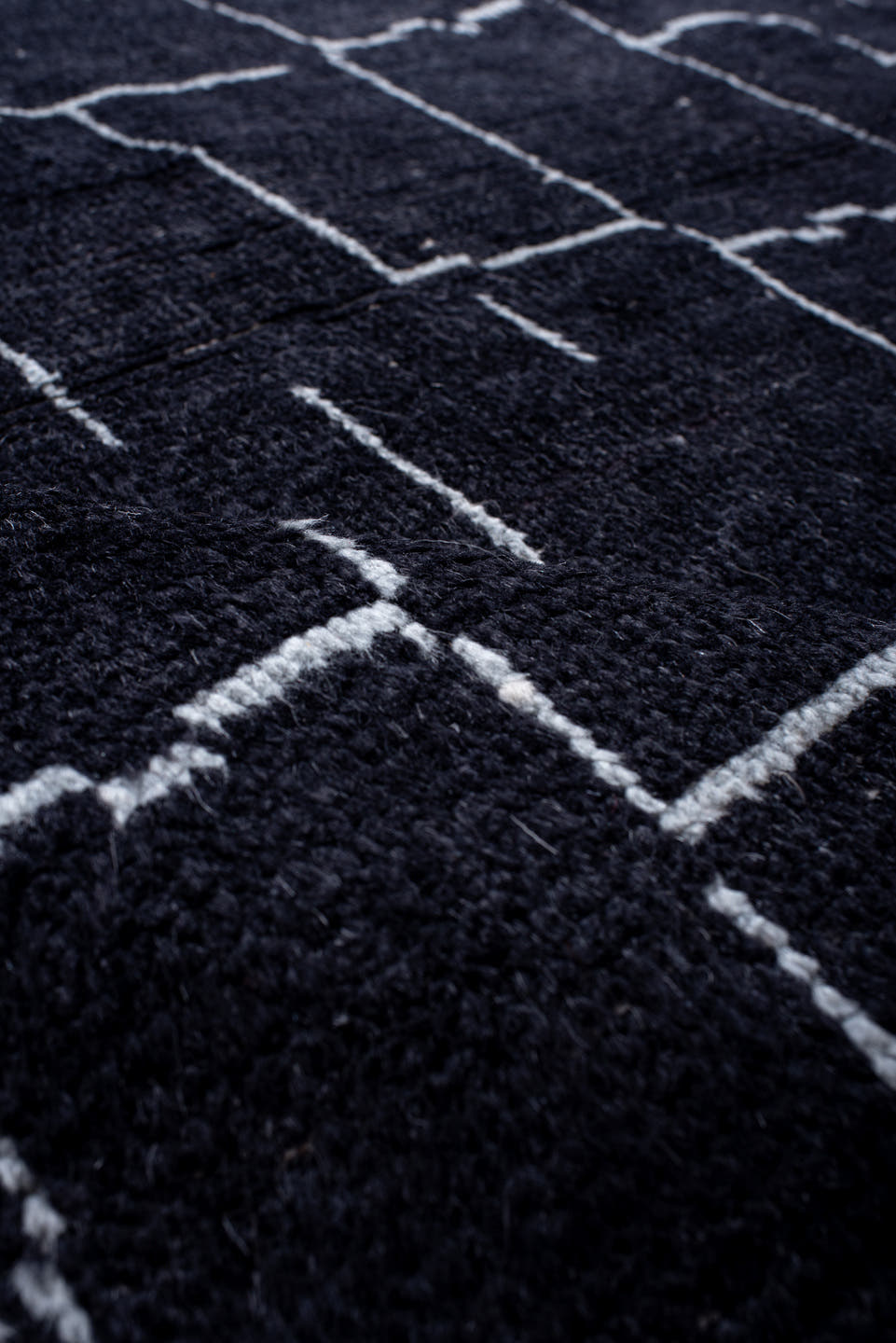 7' x 9' one-of-a-kind handmade vintage Moroccan rug. Color palette: black, ivory