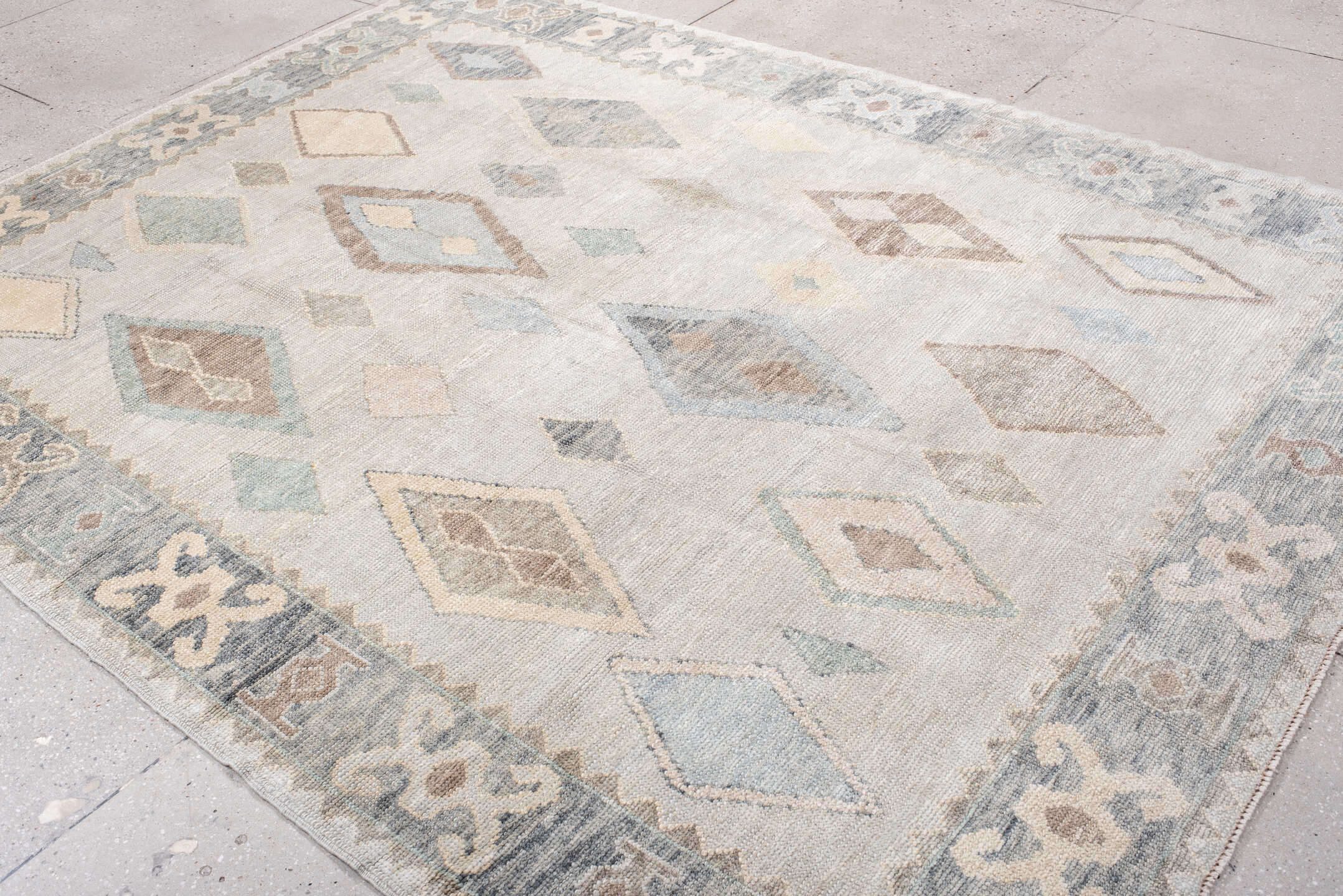 7' x 10' one-of-a-kind handmade vintage Oushak large size rug. Color palette: ivory, pale blue, taupe, cream, sage, camel