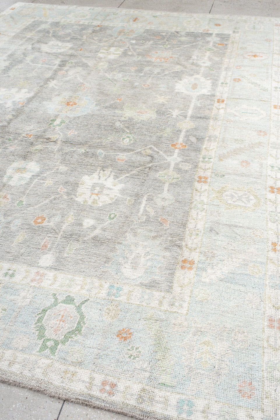 9' x 12' one-of-a-kind handmade vintage Oushak large size rug. Color palette: light gray, ivory, pale blue, sage, soft peach