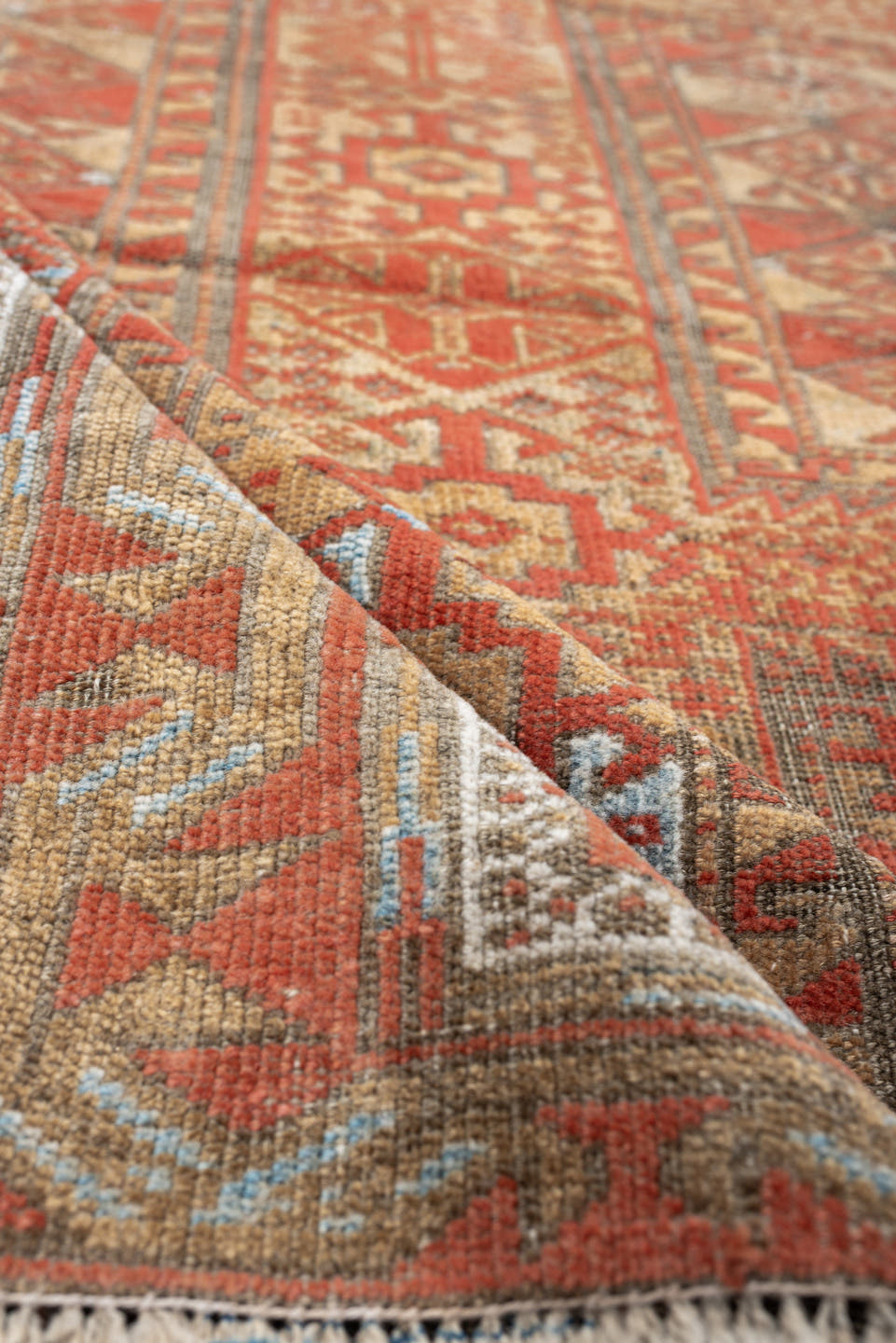 3' x 7' one-of-a-kind handmade antique Belouch rug. Color palette: terracotta, ivory, camel, taupe, rust, pale blue, brown