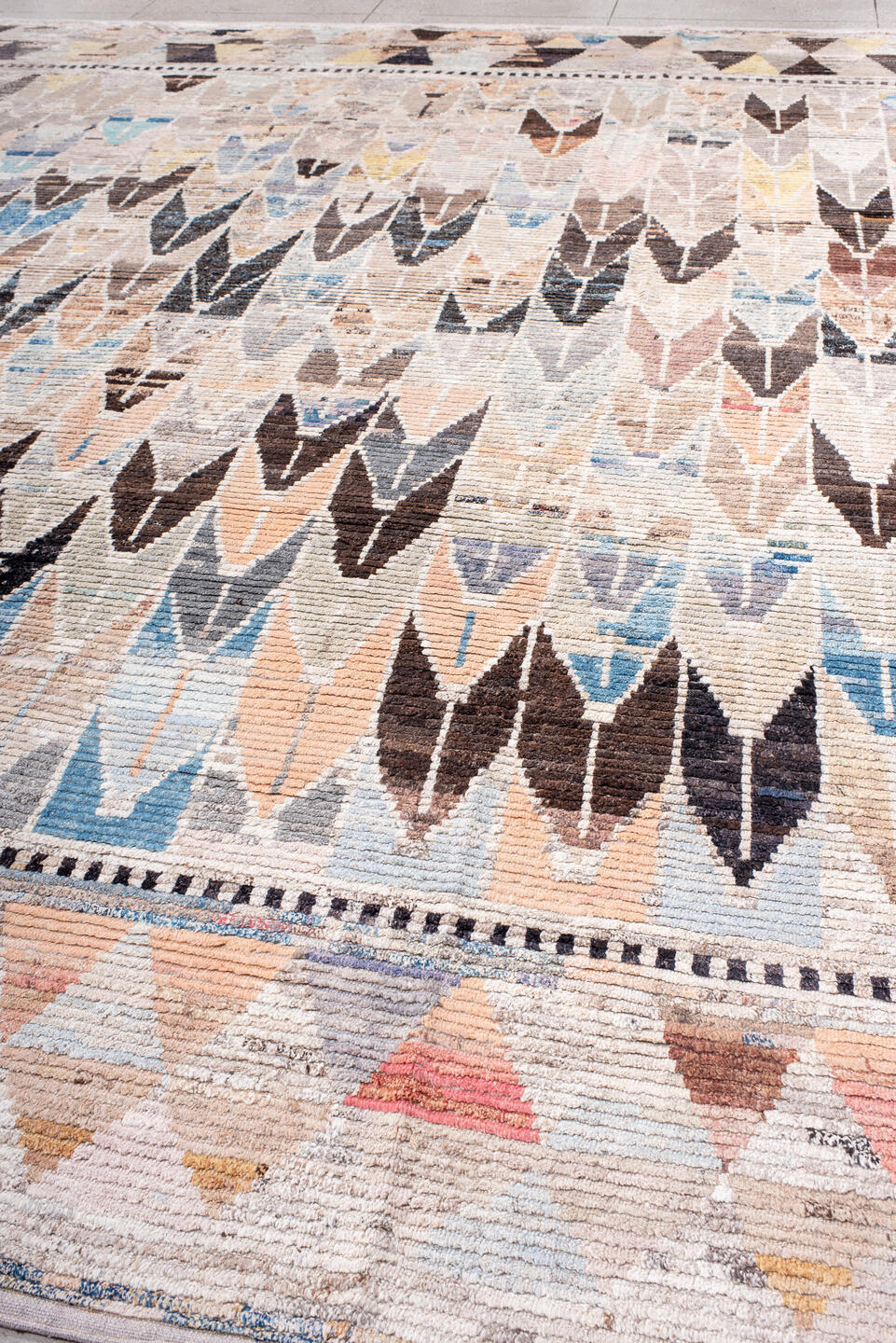 12' x 15' one-of-a-kind handmade vintage Tulu oversize rug. Color palette: ivory, charcoal, sky blue, blush, taupe