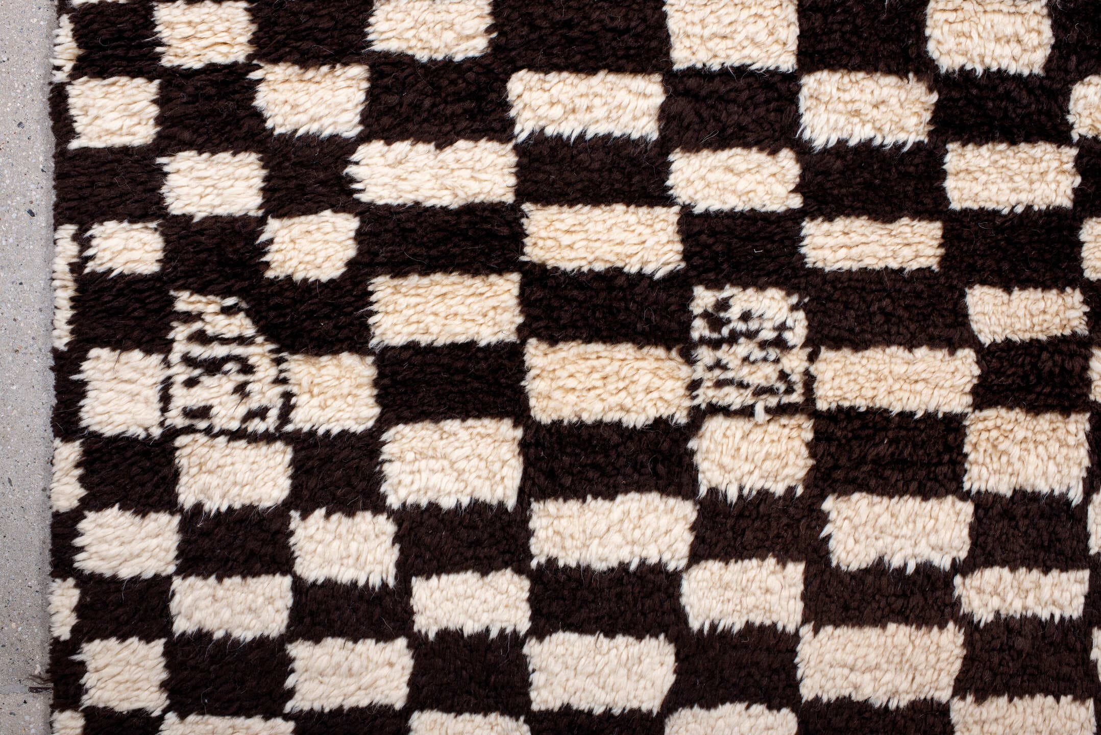 7' x 9' one-of-a-kind handmade vintage Moroccan rug. Color palette: ivory, brown, black, cream