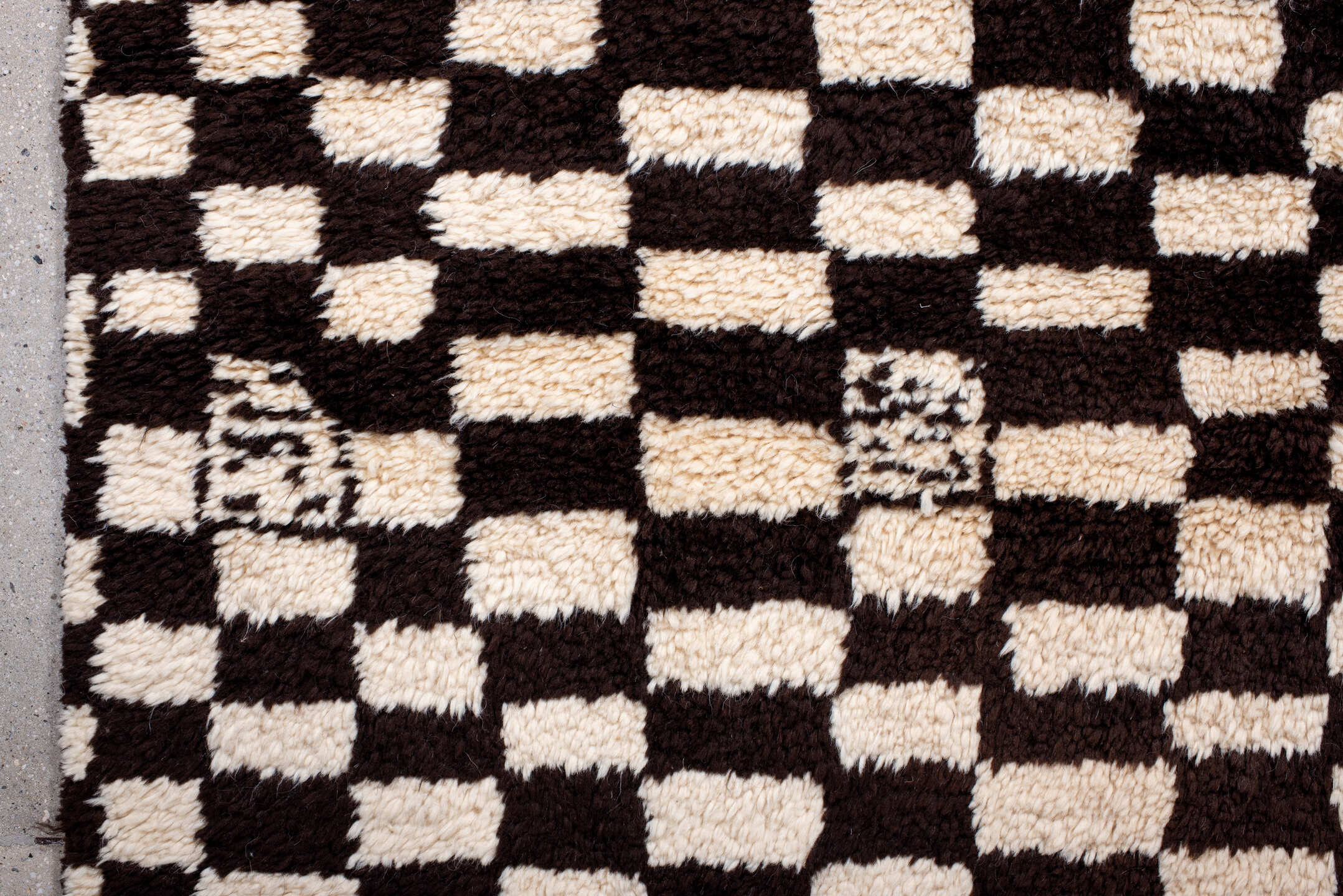7' x 9' one-of-a-kind handmade vintage Moroccan rug. Color palette: ivory, brown, black, cream