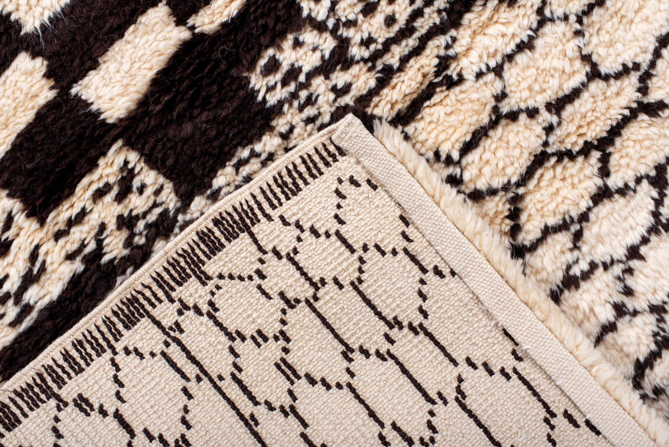 7' x 9' one-of-a-kind handmade vintage Moroccan rug. Color palette: ivory, brown, black, cream