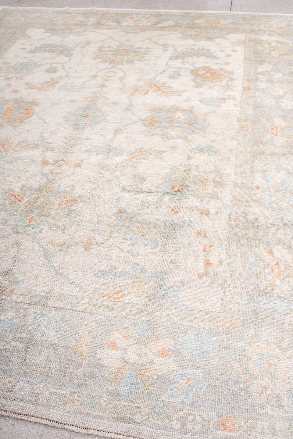 8' x 10' one-of-a-kind handmade vintage Oushak large size rug. Color palette: ivory, pale blue, blush, cream, taupe, peach