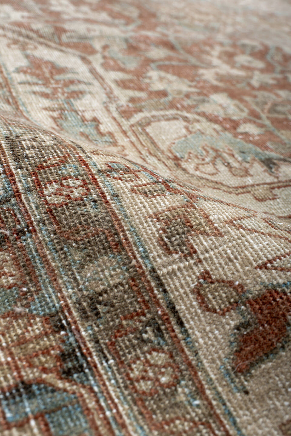 7' x 9' one-of-a-kind handmade antique Heriz rug. Color palette: ivory, sky blue, rust, taupe, camel, brown, light blue